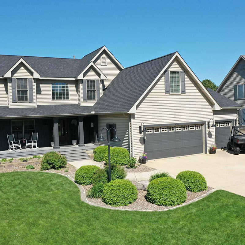 Large home with wide driveway and yard in La Salle, IL, representing trusted local roofing services.